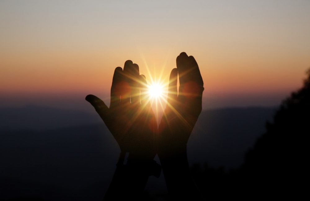 spiritual-prayer-hands-sun-shine-with-blurred-beautiful-sunset